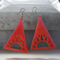 Love For Resin coral-pink geometric triangle earrings with a cut-out sunburst motif and gold-toned hooks.